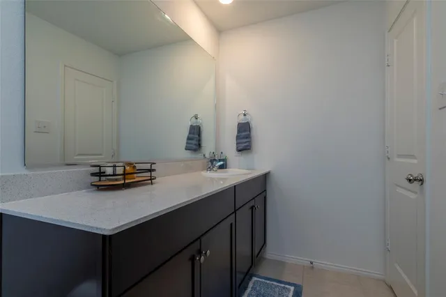 a living room with furniture and a baby crib