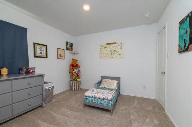 a view of room with toys and dresser