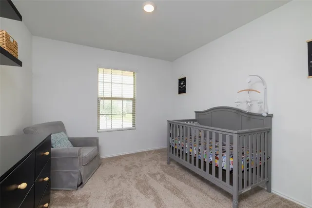 a view of a hallway to room with wooden floor and stairs