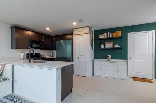 a kitchen with stainless steel appliances a refrigerator sink and cabinets