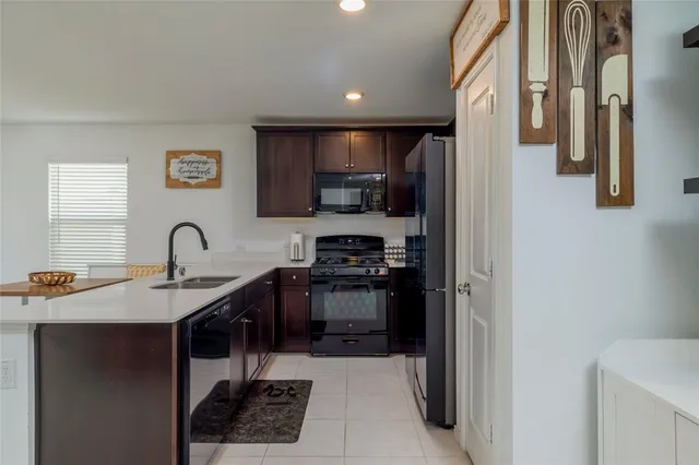 a kitchen with a sink and a refrigerator
