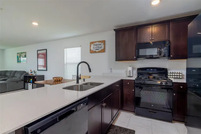 a kitchen with stainless steel appliances granite countertop a sink stove and cabinets