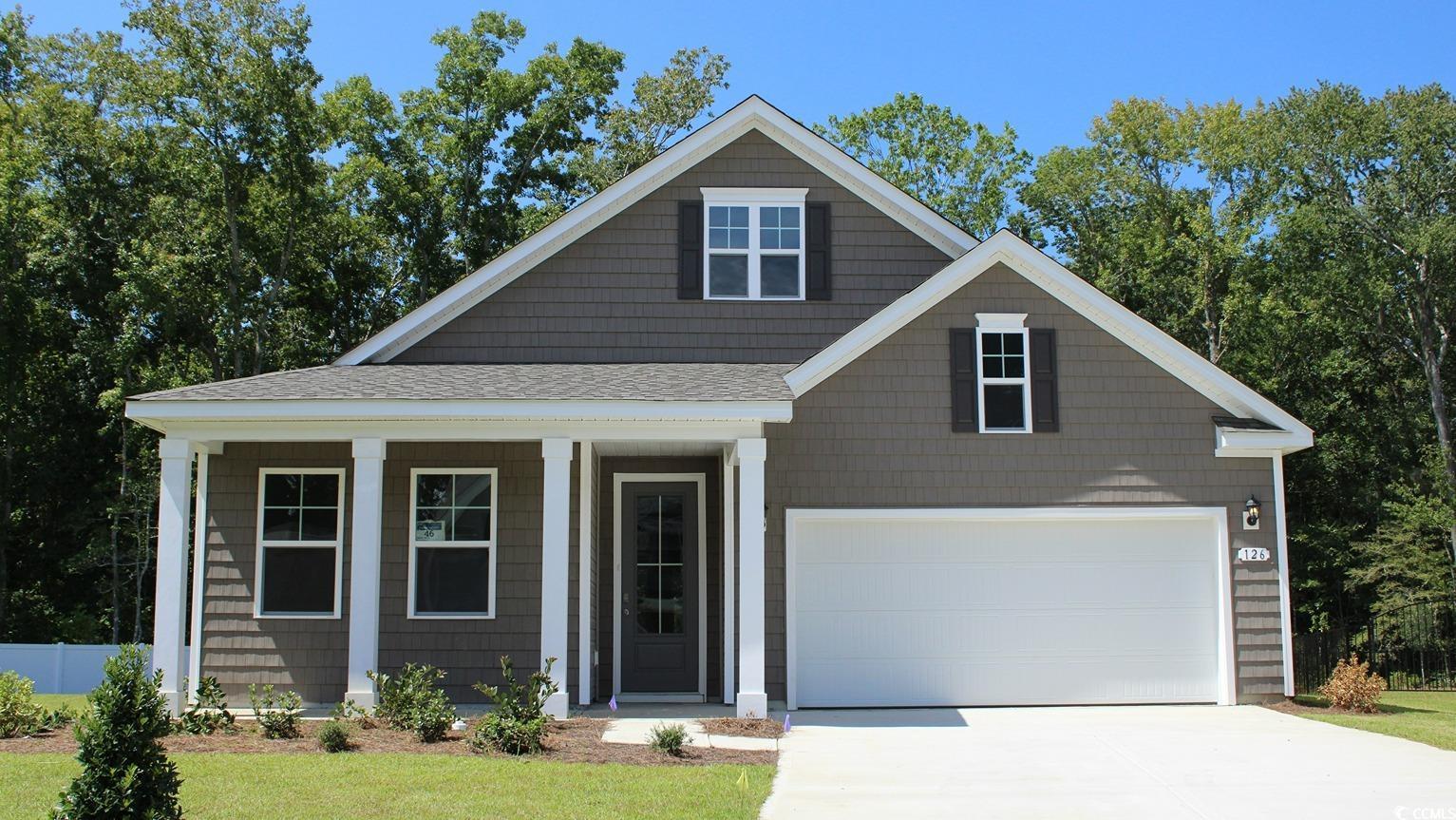 View of front facade with a porch, concrete driveway, a shingled roof, and an attached garage