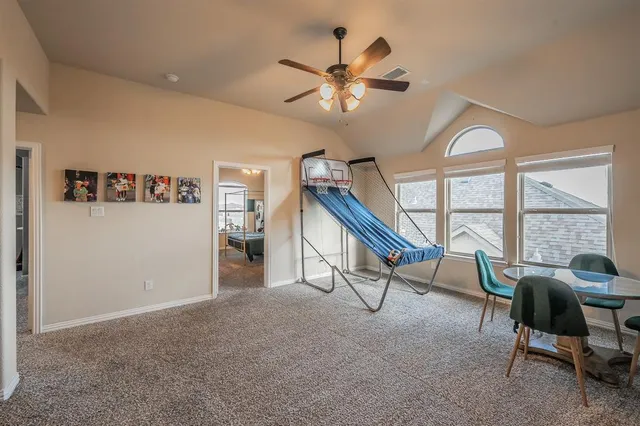 a view of a livingroom with furniture and a ceiling fan