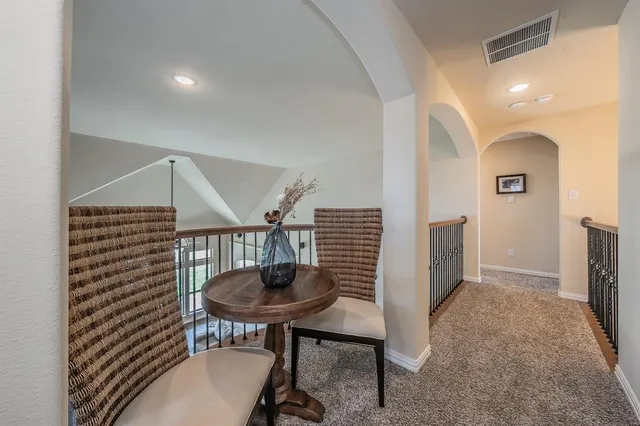 a balcony view with chairs and wooden floor