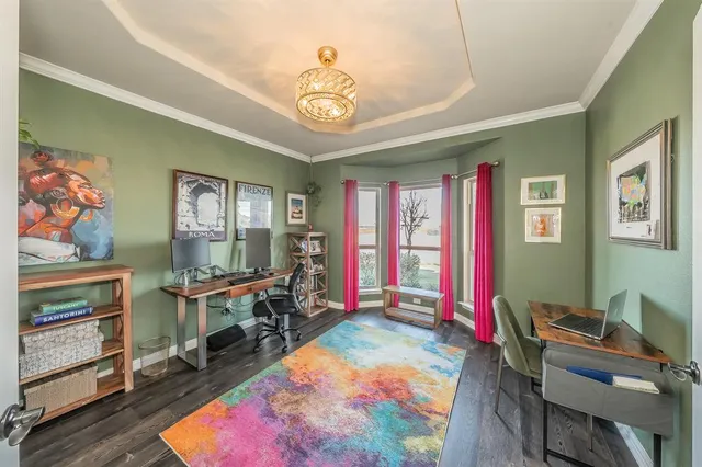 a view of a workspace with furniture window and wooden floor