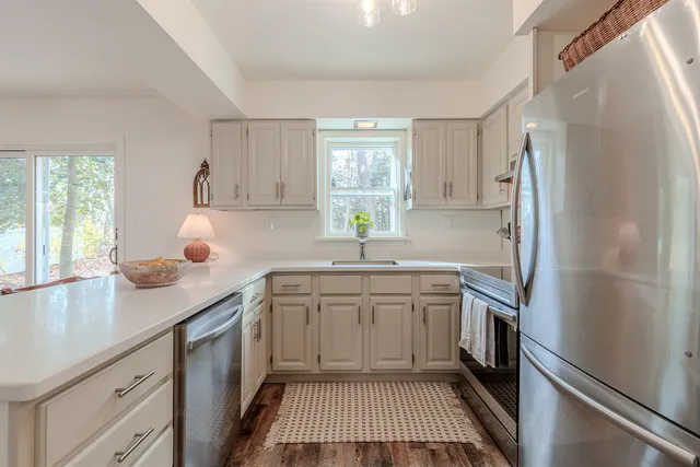 a kitchen with a sink stove and refrigerator