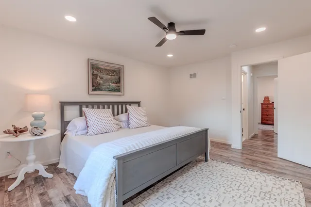a bedroom with a large bed and a chandelier