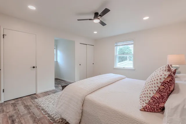 a bedroom with a large bed and a window