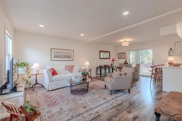 a living room with furniture and wooden floor