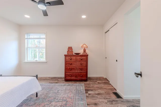 a room with a dresser and a window