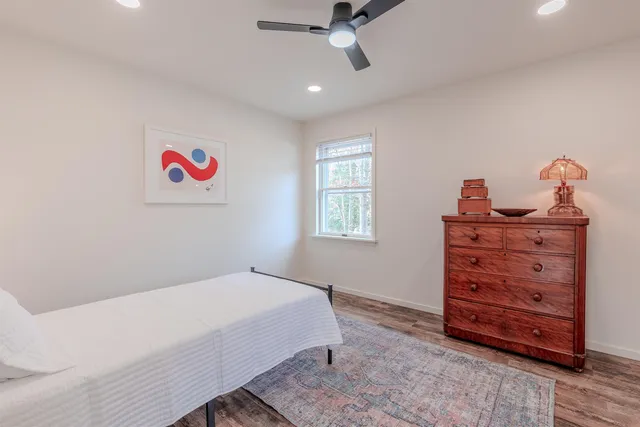 a bedroom with a bed and a dresser