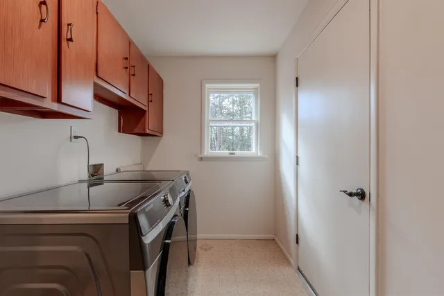 a kitchen with a sink cabinets and a window