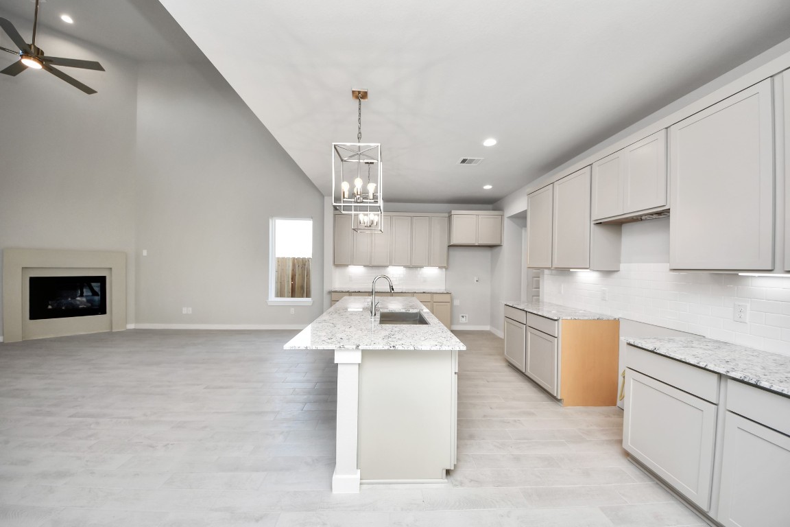 15802 Telge Ridge Lane Cypress, TX 77429 - Photo 19 of 45 a large kitchen with stainless steel appliances kitchen island granite countertop a sink and a stove