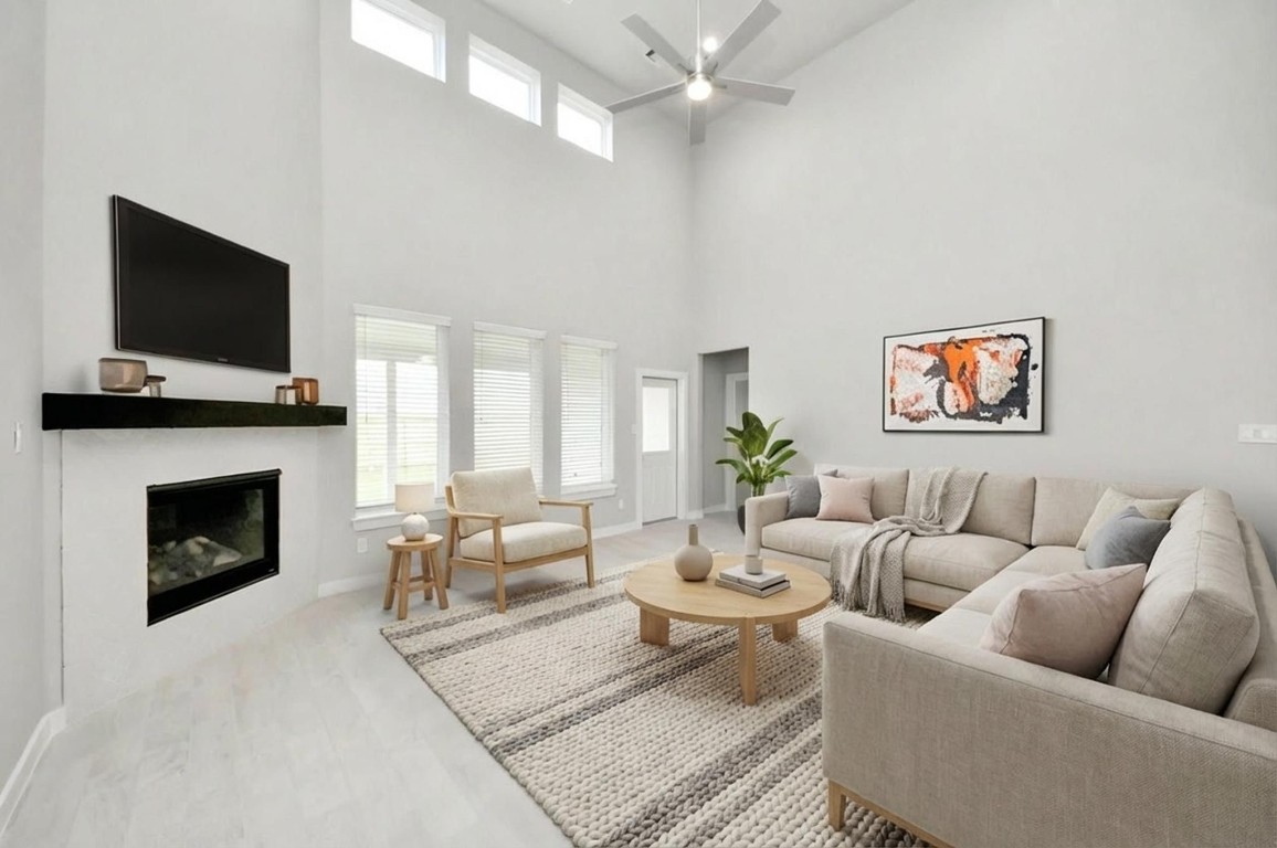 15802 Telge Ridge Lane Cypress, TX 77429 - Photo 27 of 45 a living room with furniture a flat screen tv and a fireplace