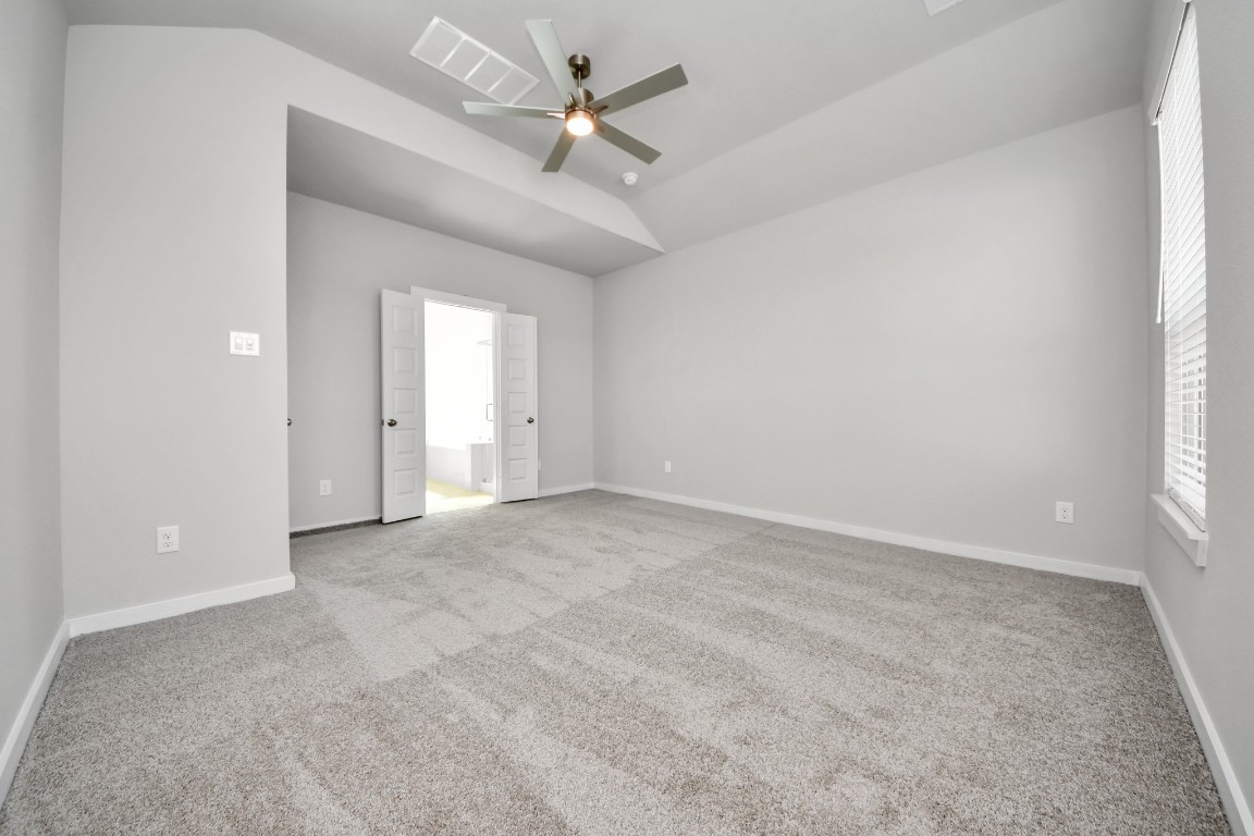 15802 Telge Ridge Lane Cypress, TX 77429 - Photo 31 of 45 an empty room with a ceiling fan and a window