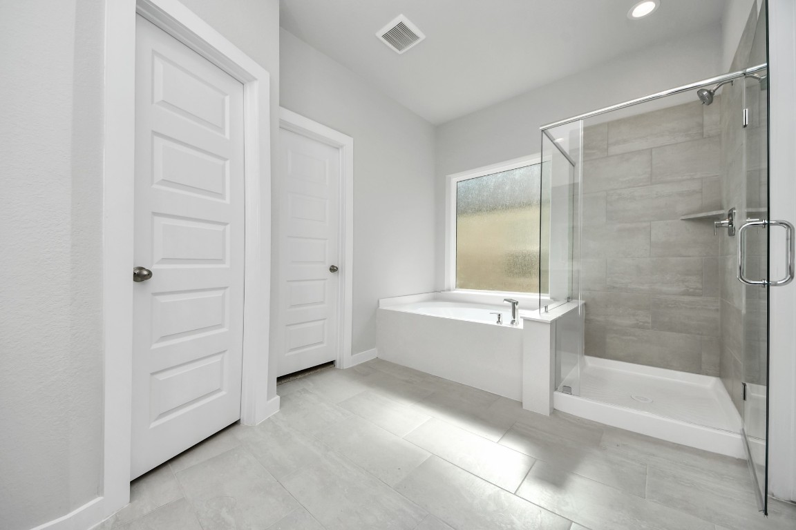15802 Telge Ridge Lane Cypress, TX 77429 - Photo 32 of 45 a bathroom with a bathtub and a shower