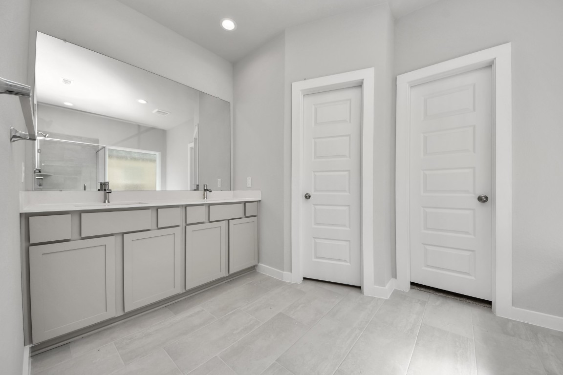 15802 Telge Ridge Lane Cypress, TX 77429 - Photo 33 of 45 a bathroom with a double vanity sink and a mirror