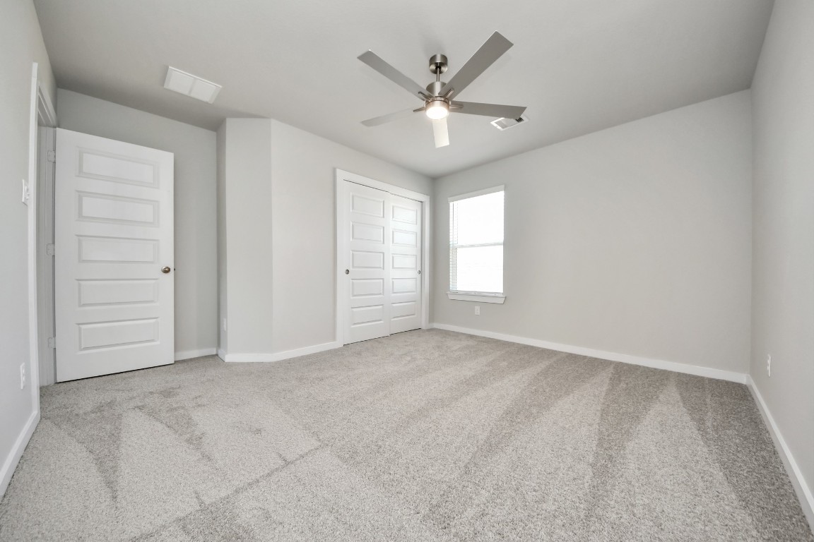 15802 Telge Ridge Lane Cypress, TX 77429 - Photo 41 of 45 an empty room with windows and fan