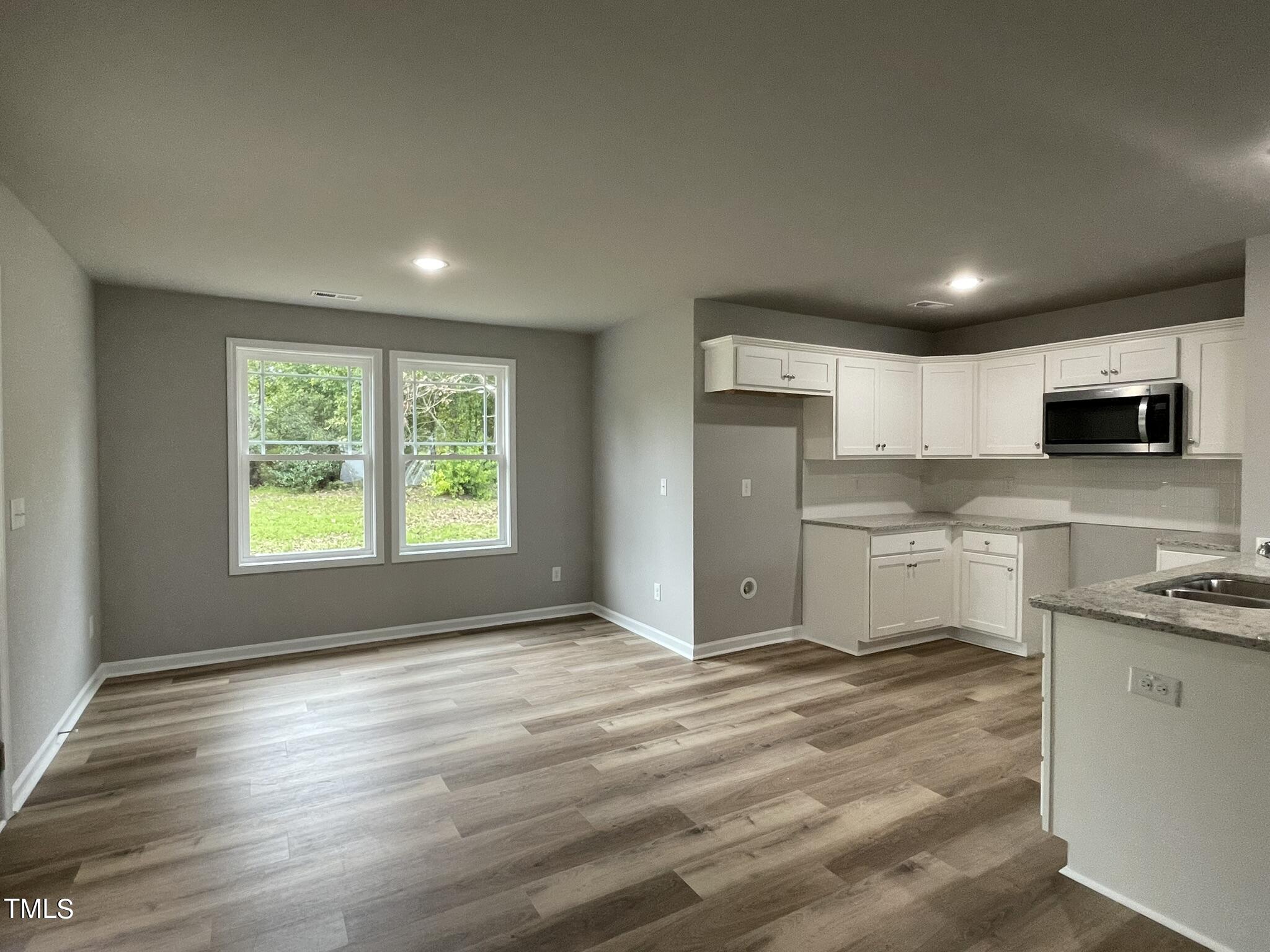 329 Ewing Drive Selma, NC 27576 - Photo 3 of 17 a kitchen with stainless steel appliances granite countertop a stove a sink and a refrigerator