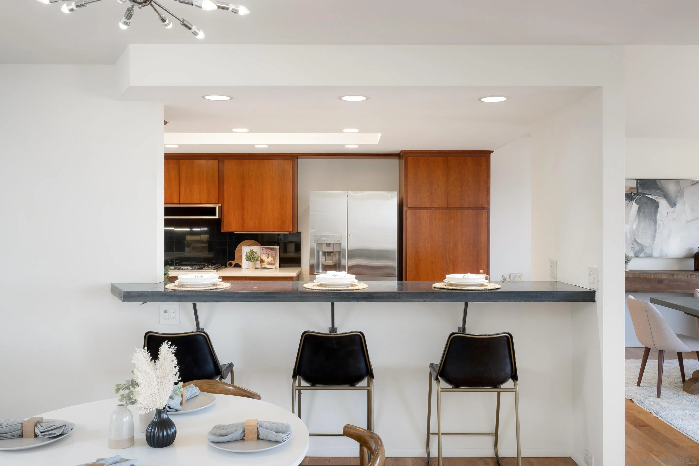 5665 Soledad Mountain Road La Jolla, CA 92037 - Photo 12 of 52 a kitchen with stainless steel appliances kitchen island granite countertop a sink and cabinets