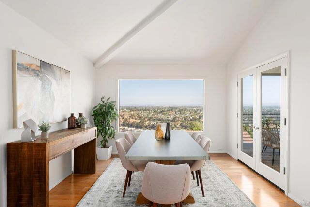 a view of a dining room with furniture window and wooden floor