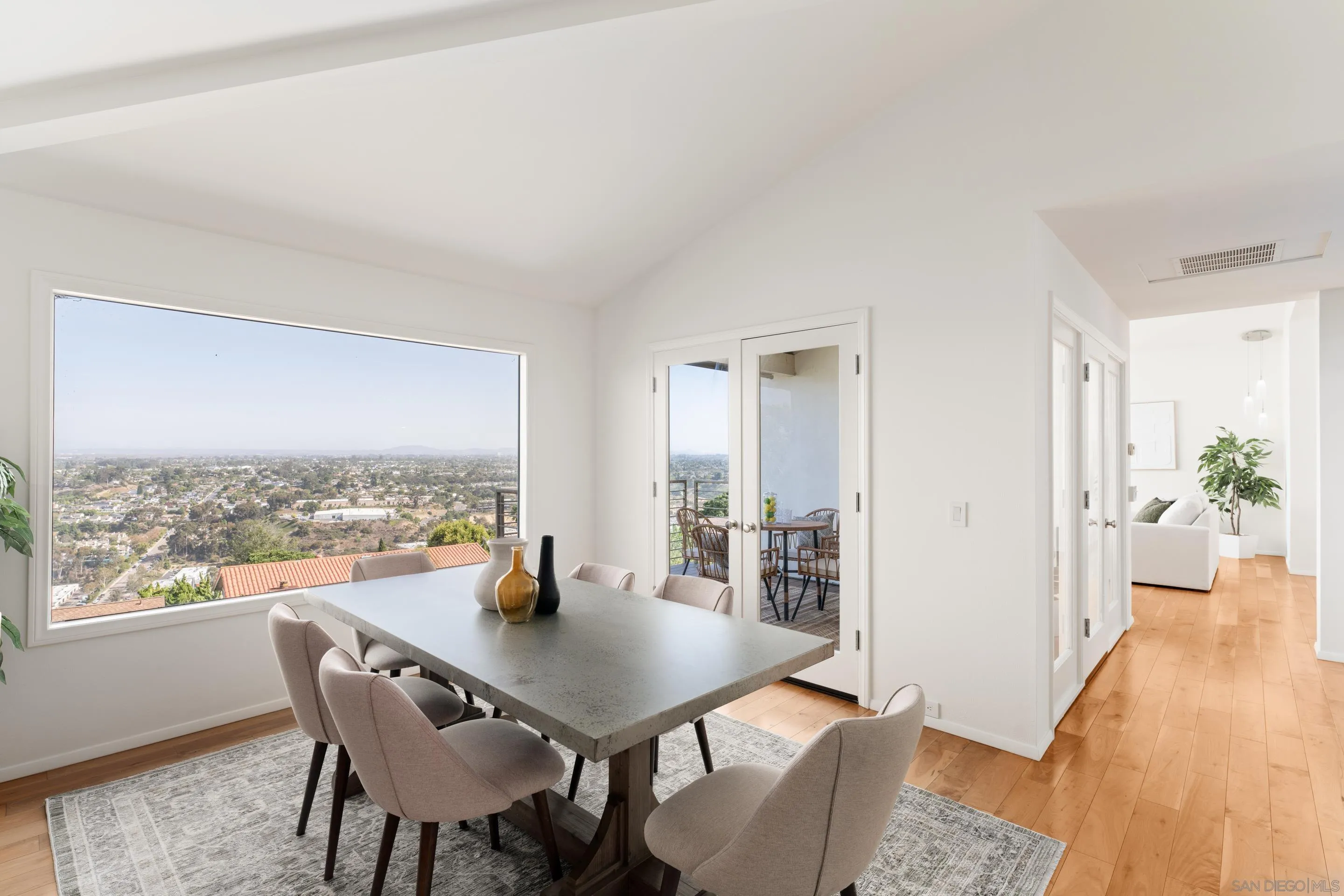 5665 Soledad Mountain Road La Jolla, CA 92037 - Photo 14 of 52 a view of a dining room with furniture window and wooden floor