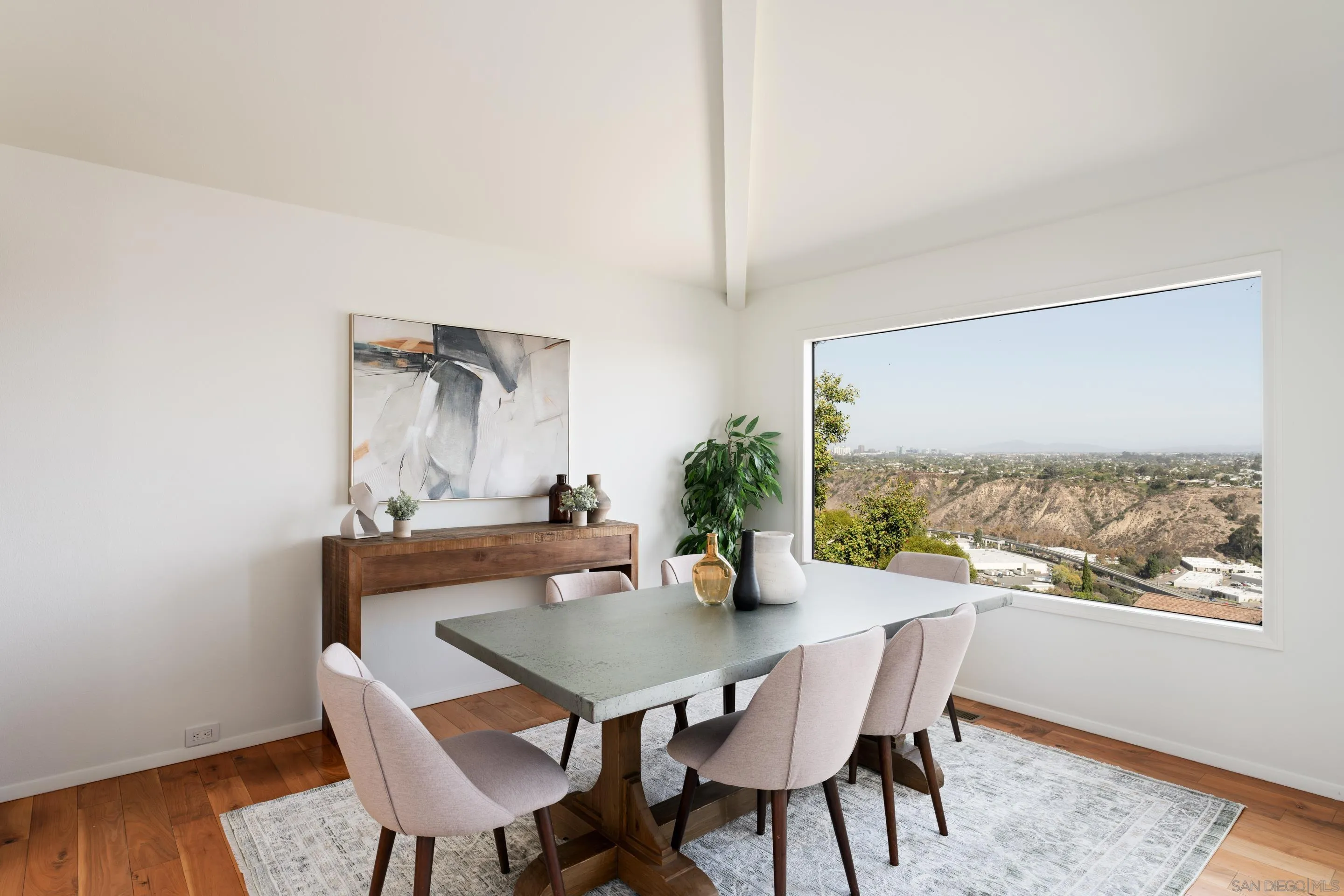 5665 Soledad Mountain Road La Jolla, CA 92037 - Photo 15 of 52 a view of a dining room with furniture and wooden floor