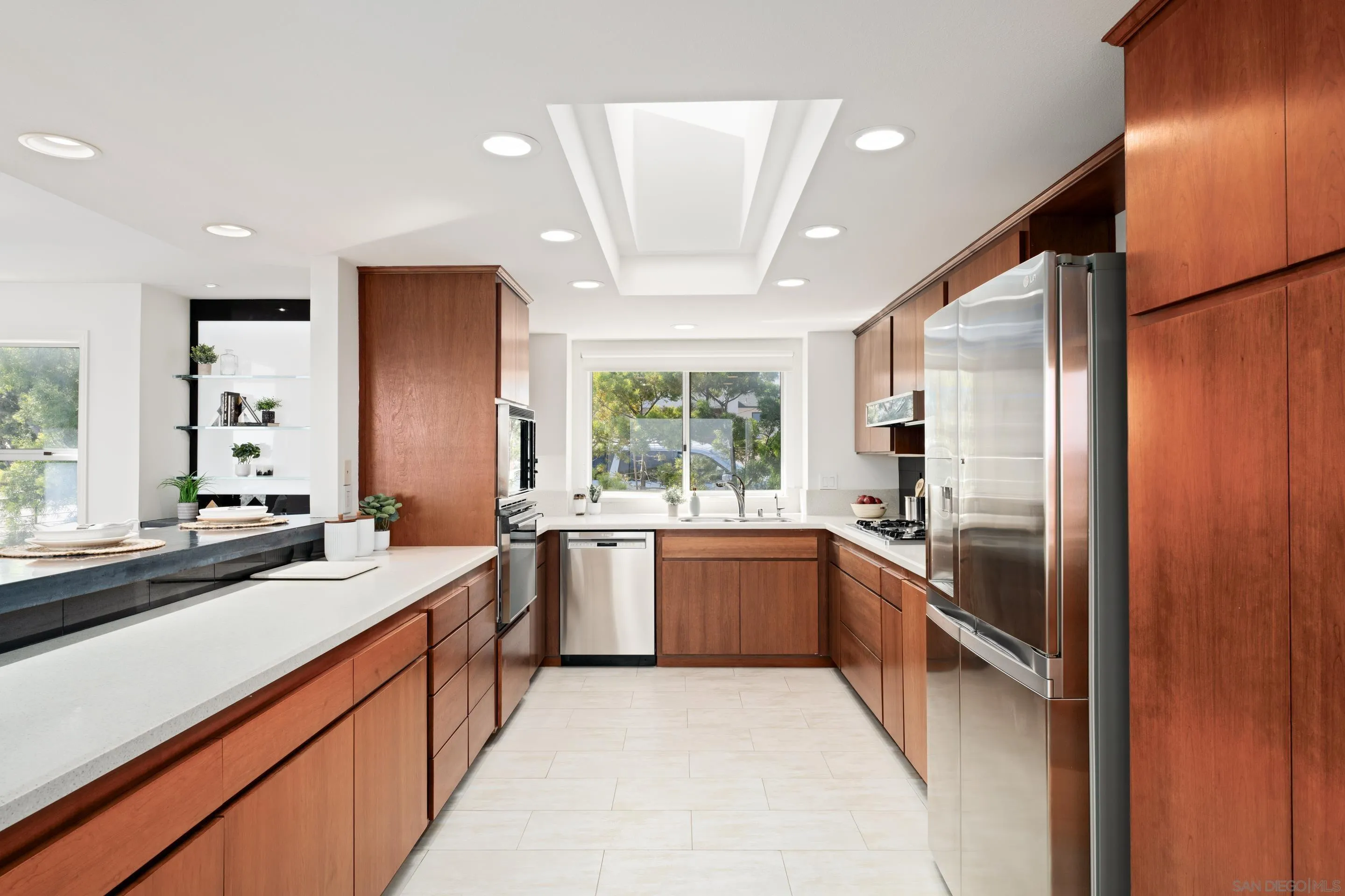 5665 Soledad Mountain Road La Jolla, CA 92037 - Photo 18 of 52 a large kitchen with stainless steel appliances granite countertop cabinets and a large window