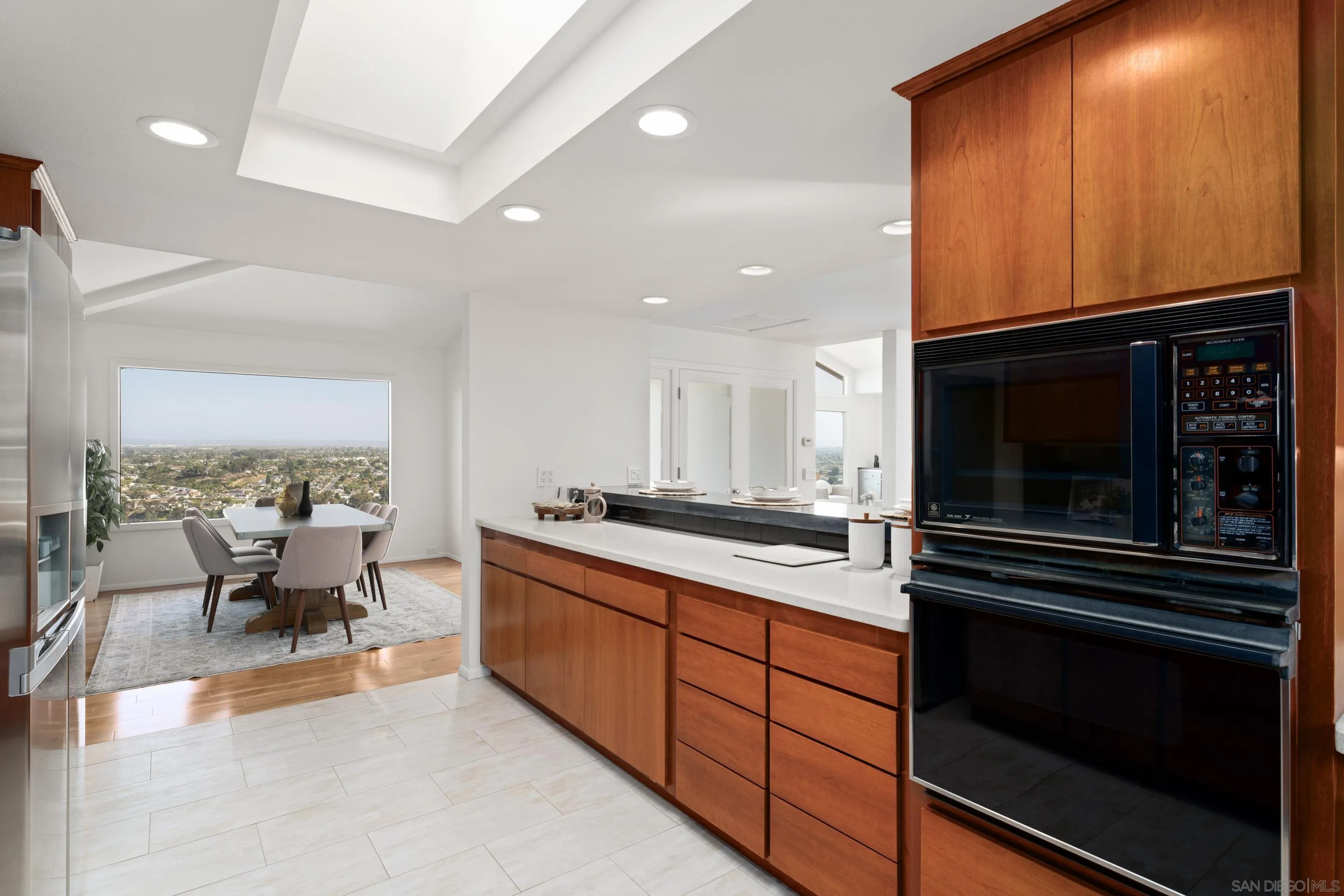 5665 Soledad Mountain Road La Jolla, CA 92037 - Photo 20 of 52 a kitchen with stainless steel appliances a stove a sink and a microwave