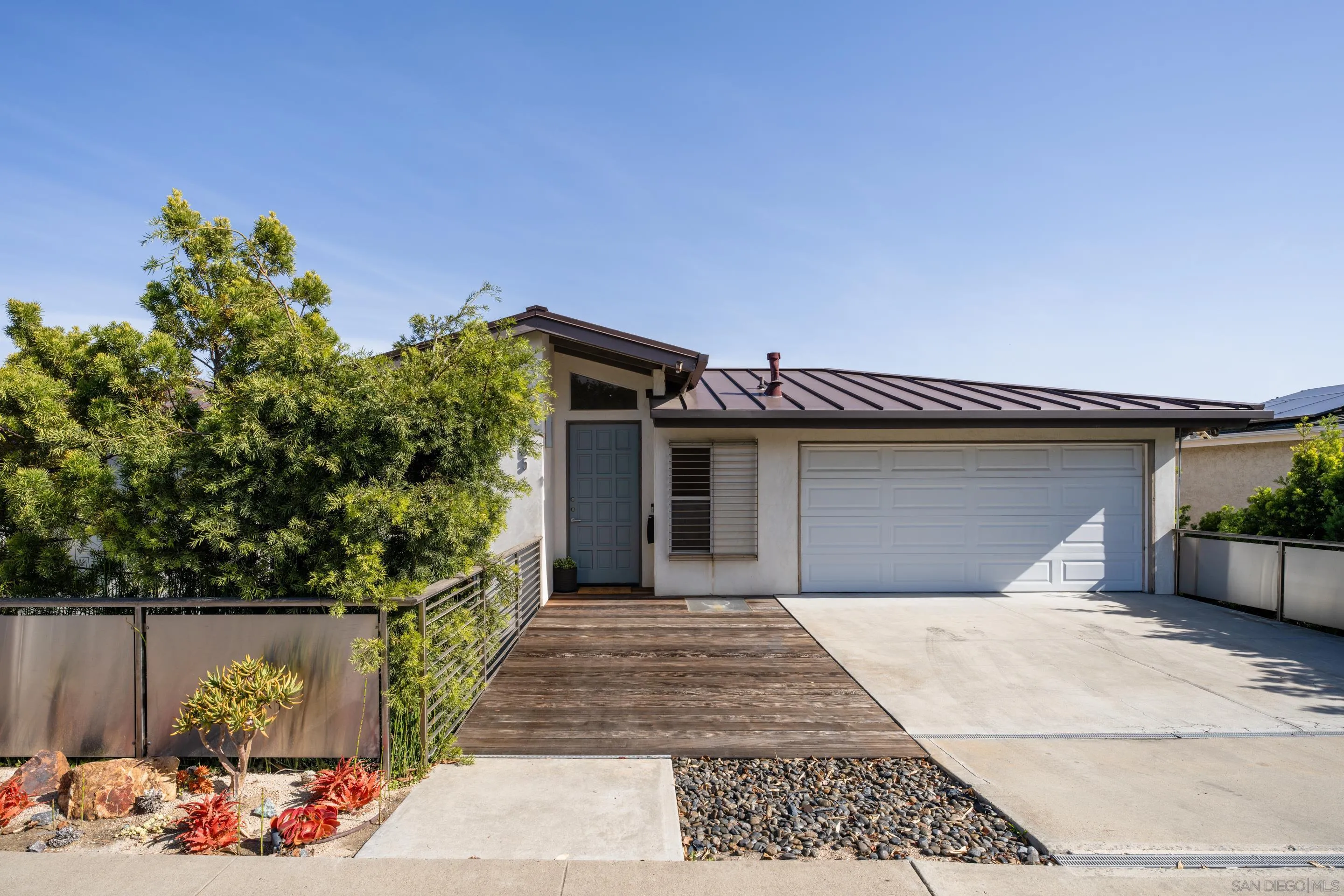 5665 Soledad Mountain Road La Jolla, CA 92037 - Photo 2 of 52 a front view of a house with a garage