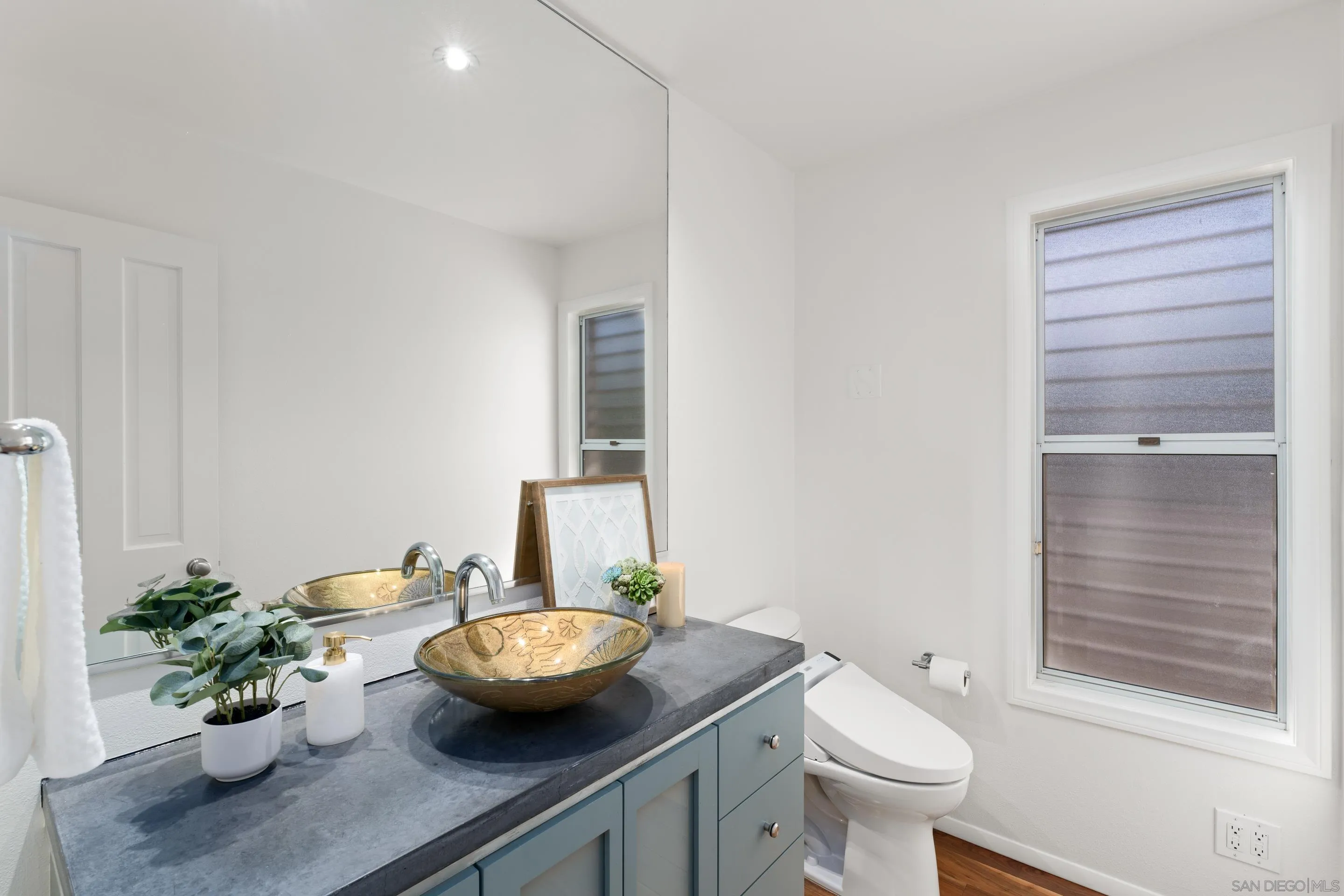 5665 Soledad Mountain Road La Jolla, CA 92037 - Photo 21 of 52 a bathroom with a granite countertop sink toilet and a mirror