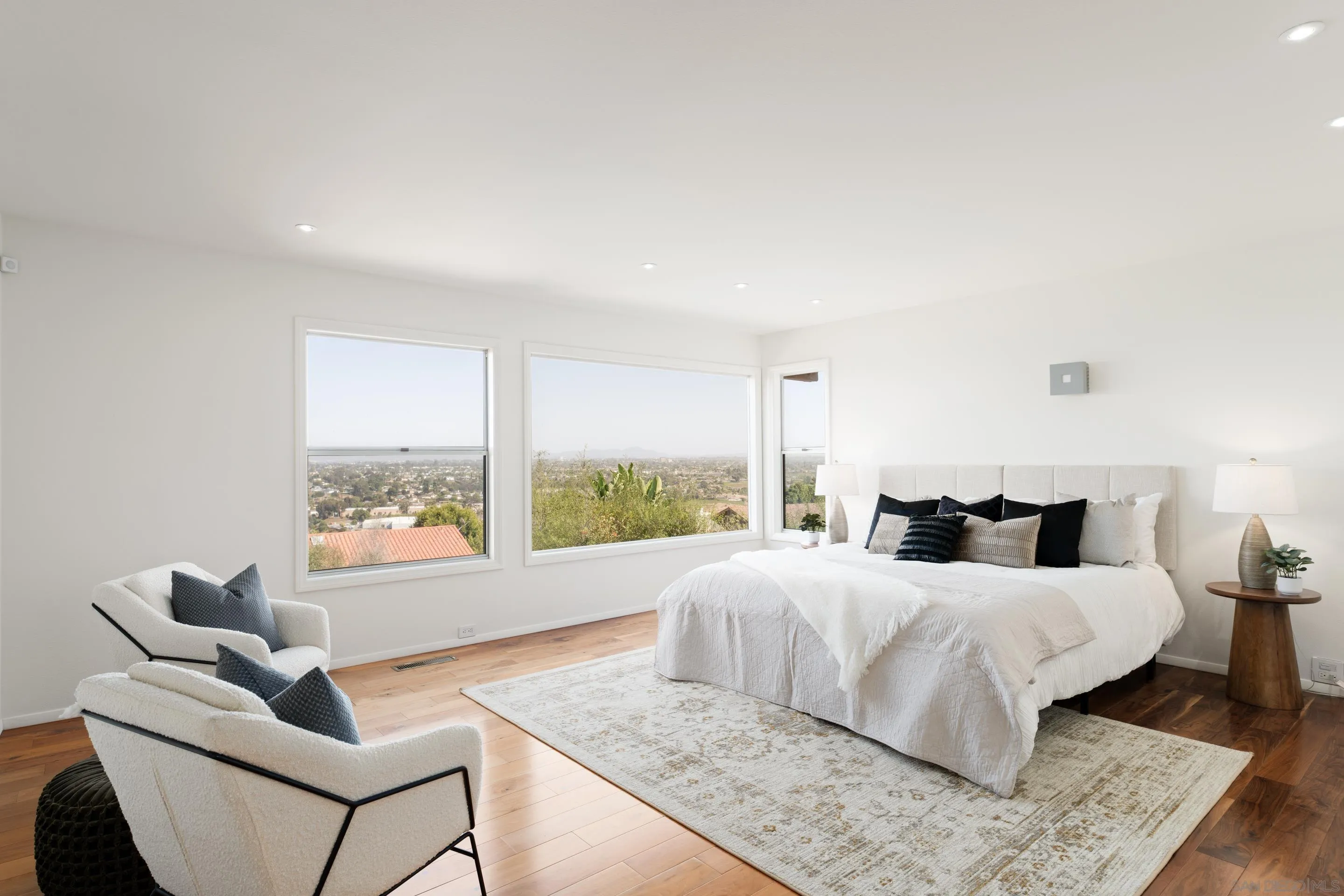 5665 Soledad Mountain Road La Jolla, CA 92037 - Photo 22 of 52 a bedroom with a large bed and a large window