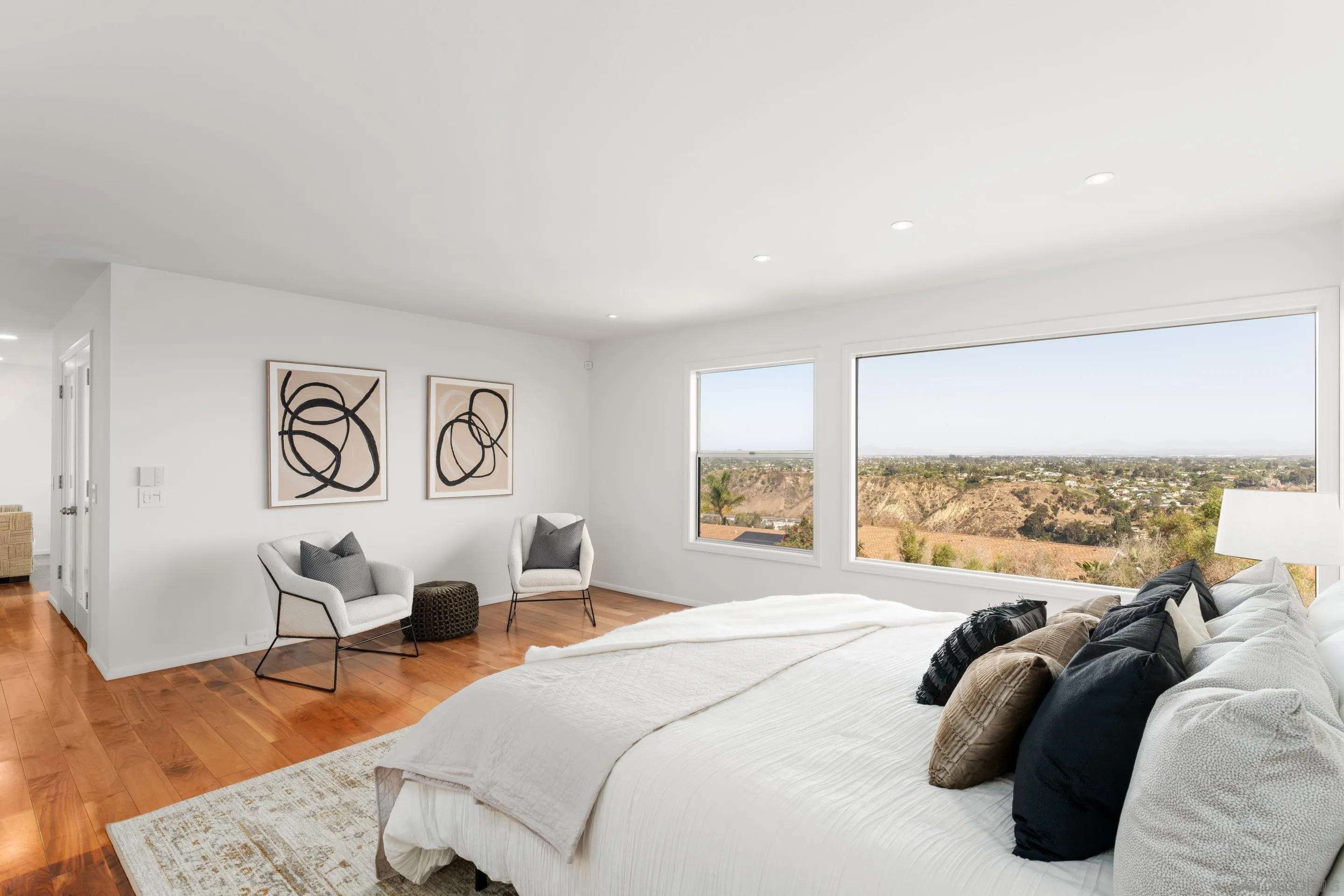 5665 Soledad Mountain Road La Jolla, CA 92037 - Photo 23 of 52 a spacious bedroom with a bed and a large window