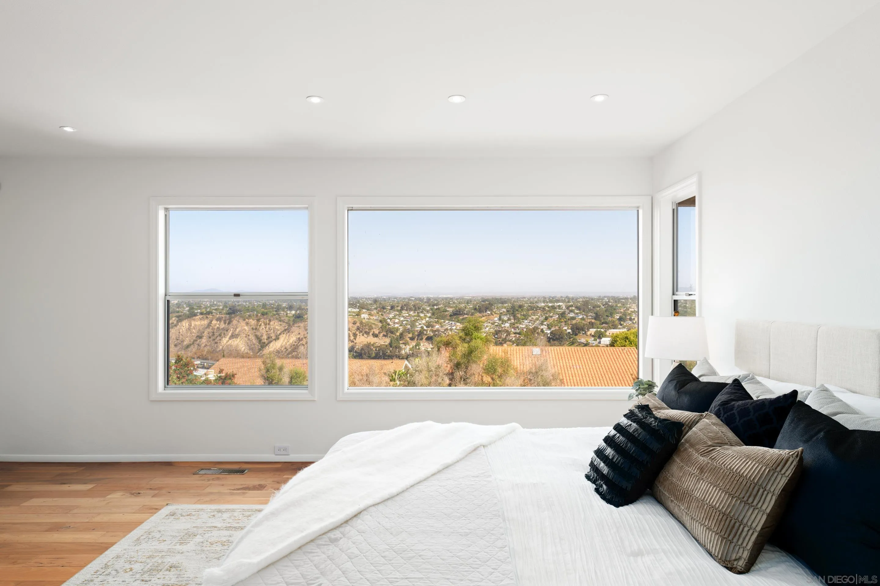 5665 Soledad Mountain Road La Jolla, CA 92037 - Photo 24 of 52 a large bed sitting in a bedroom next to a window