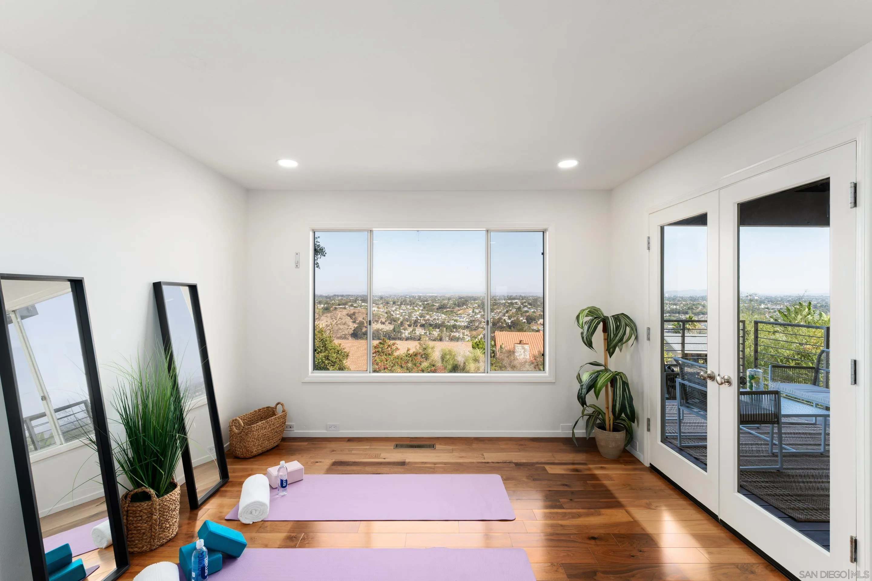 5665 Soledad Mountain Road La Jolla, CA 92037 - Photo 28 of 52 a view of an empty room with wooden floor and a potted plant