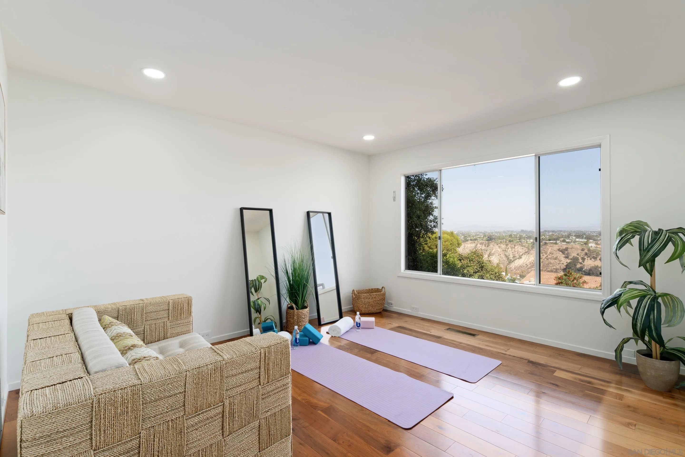5665 Soledad Mountain Road La Jolla, CA 92037 - Photo 29 of 52 a bedroom with furniture and a large window