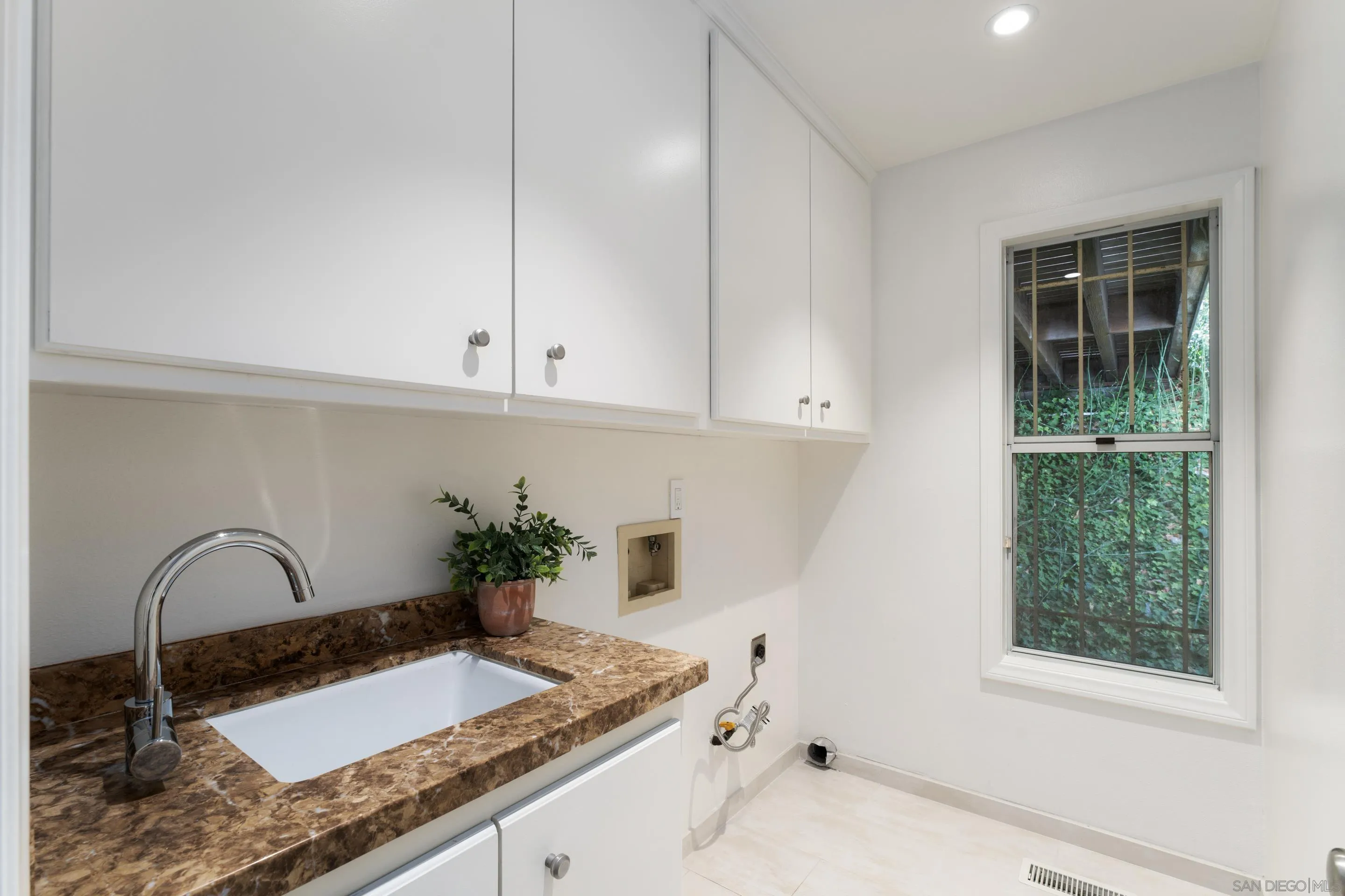 5665 Soledad Mountain Road La Jolla, CA 92037 - Photo 30 of 52 a bathroom with a granite countertop sink and a mirror