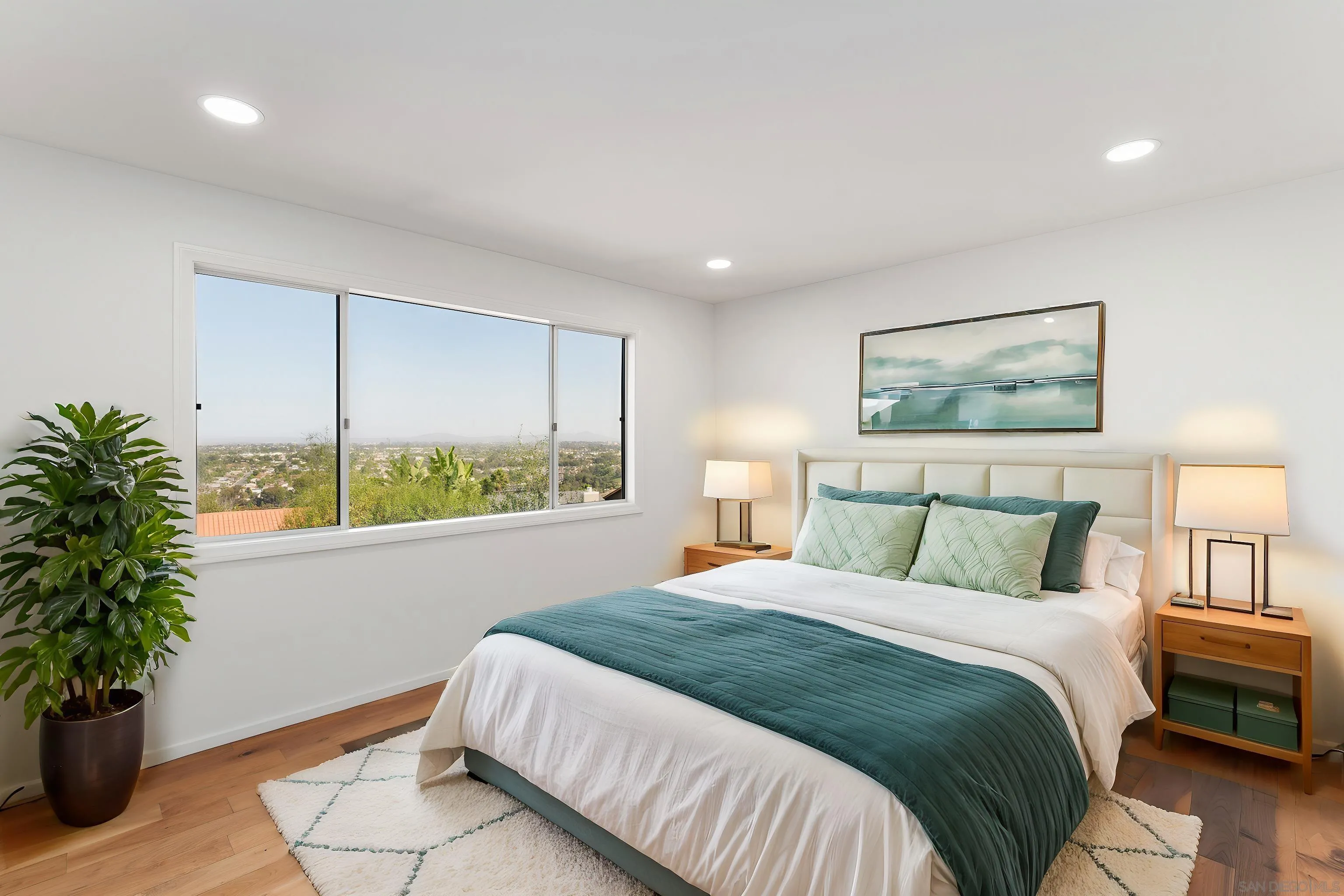 5665 Soledad Mountain Road La Jolla, CA 92037 - Photo 33 of 52 a bedroom with a large bed and a potted plant
