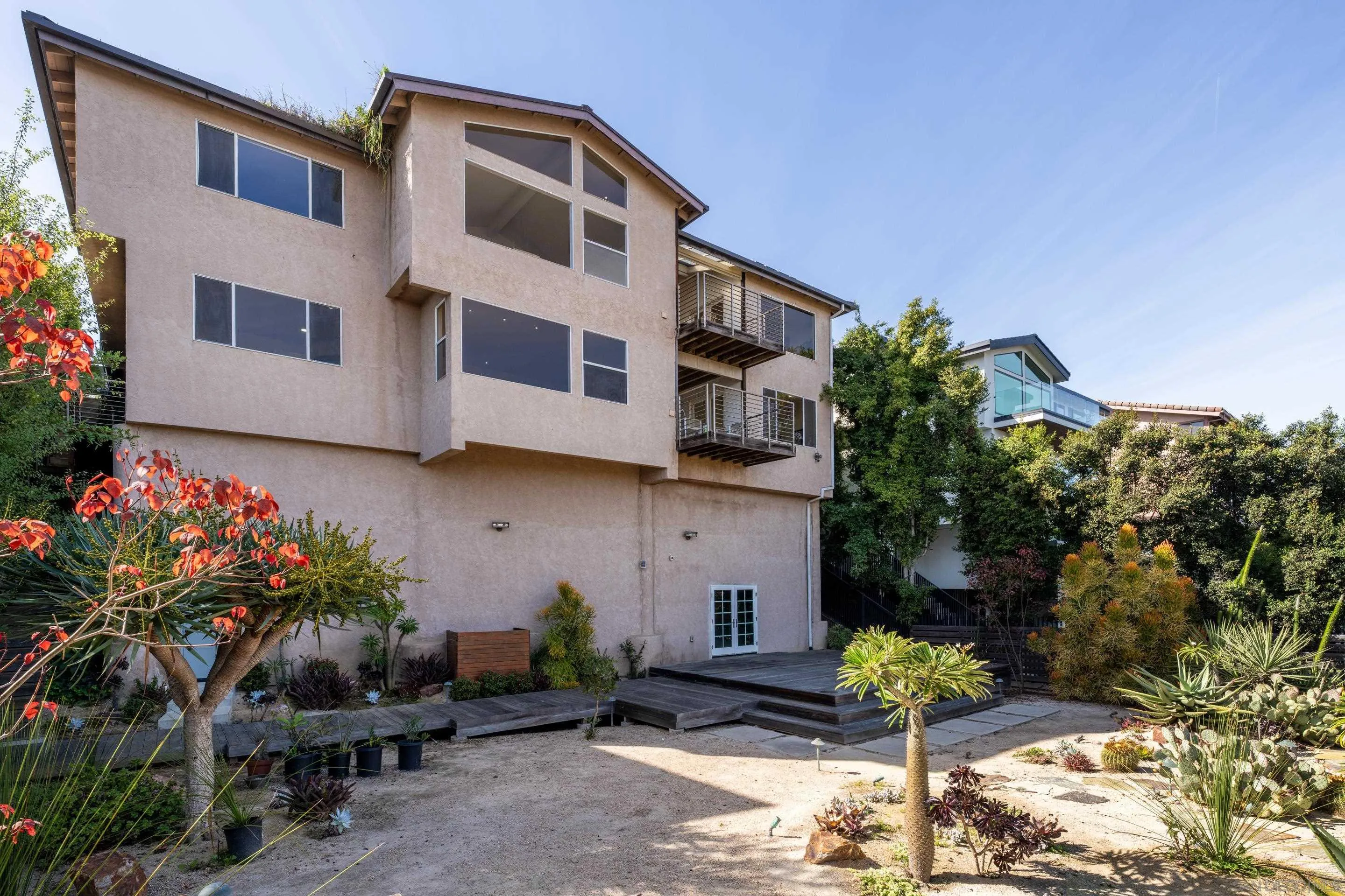 5665 Soledad Mountain Road La Jolla, CA 92037 - Photo 50 of 52 a building with potted plants in front of it