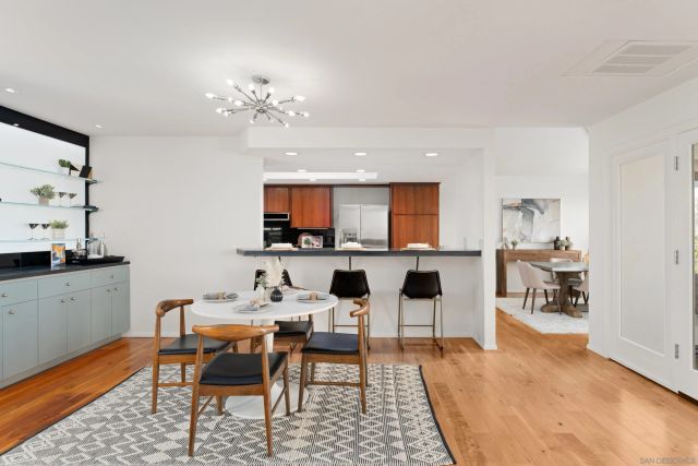 a dining room with furniture a window and kitchen view