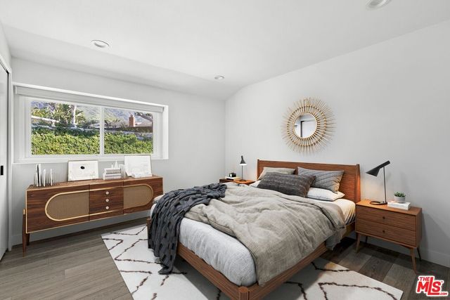 a bedroom with bed and a window