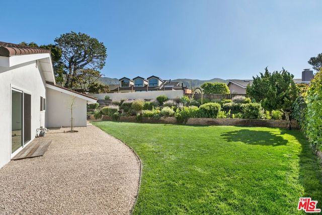 a view of a backyard of the house