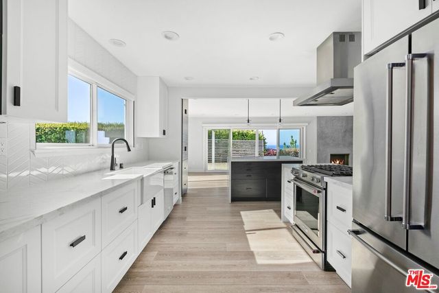 a kitchen with stainless steel appliances a sink stove and refrigerator