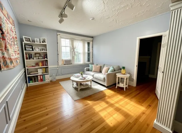 a living room with furniture and a wooden floor