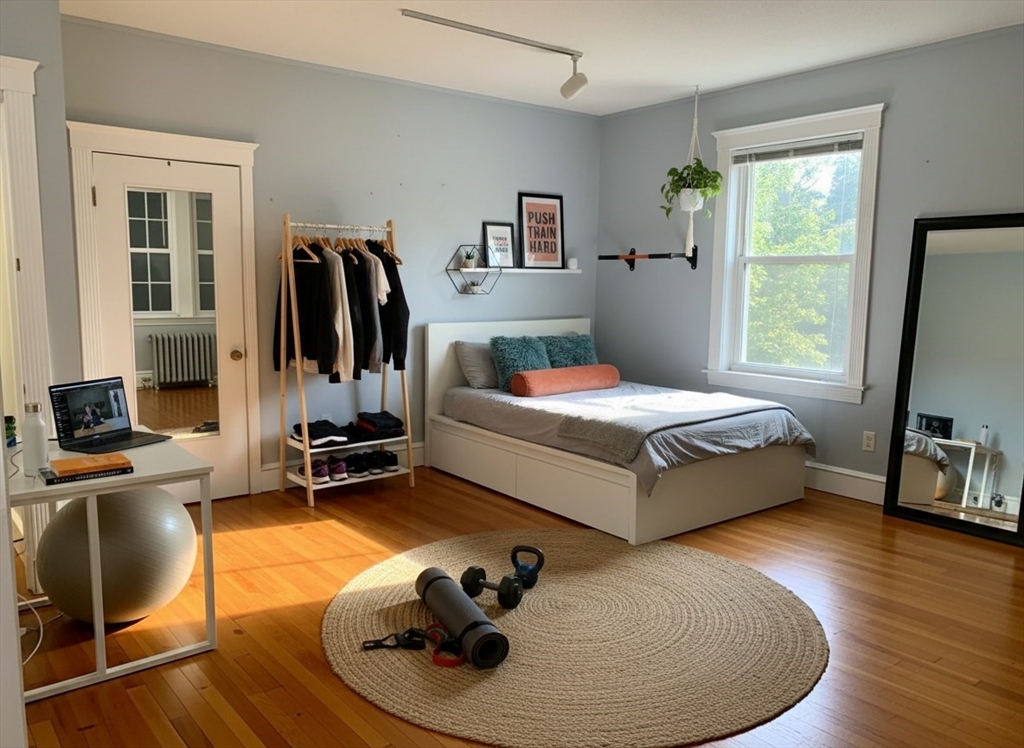 316 St Paul Street, Unit 5 Brookline, MA 02446 - Photo 4 of 7 a bedroom with a bed and wooden floor