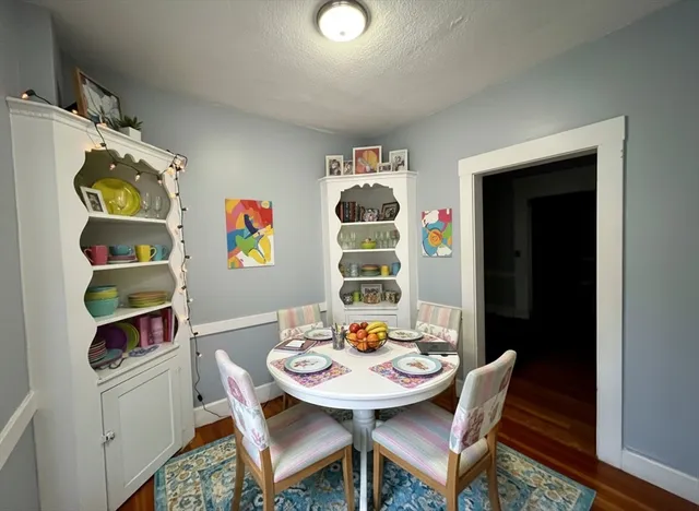 a view of a dining room with furniture and wooden floor