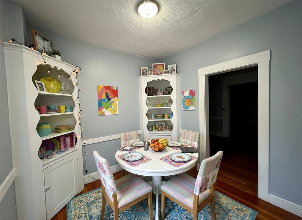 316 St Paul Street, Unit 5 Brookline, MA 02446 - Photo 6 of 7 a view of a dining room with furniture and wooden floor