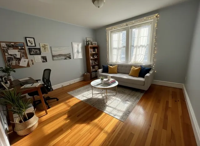 a living room with furniture a rug and a window