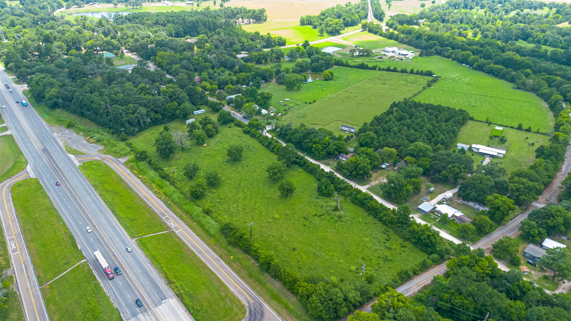 14132 North Old Highway 35 Road Moscow, TX 75960 - Photo 9 of 18 a view of a yard with a lush green forest
